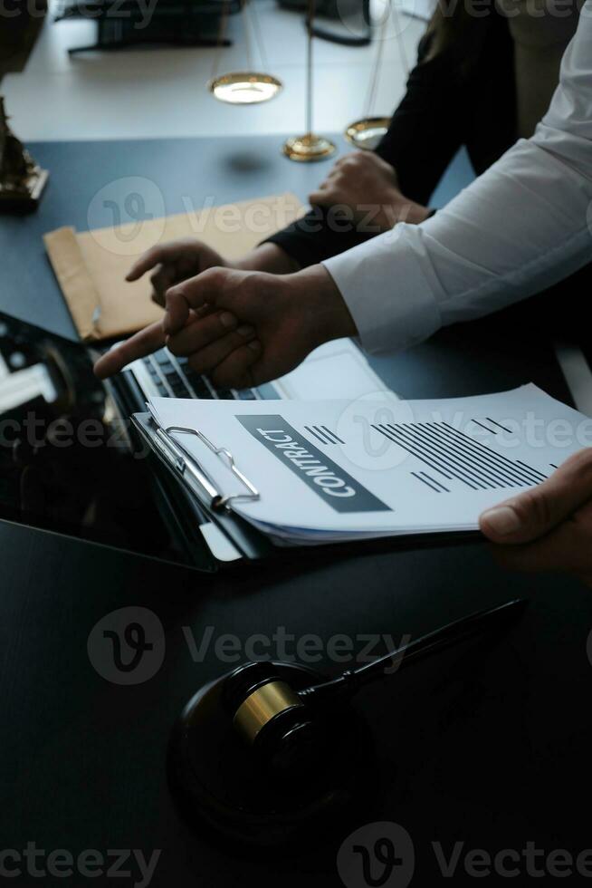 Male lawyer working with contract papers and wooden gavel on tabel in courtroom. justice and law ,attorney, court judge, concept. photo