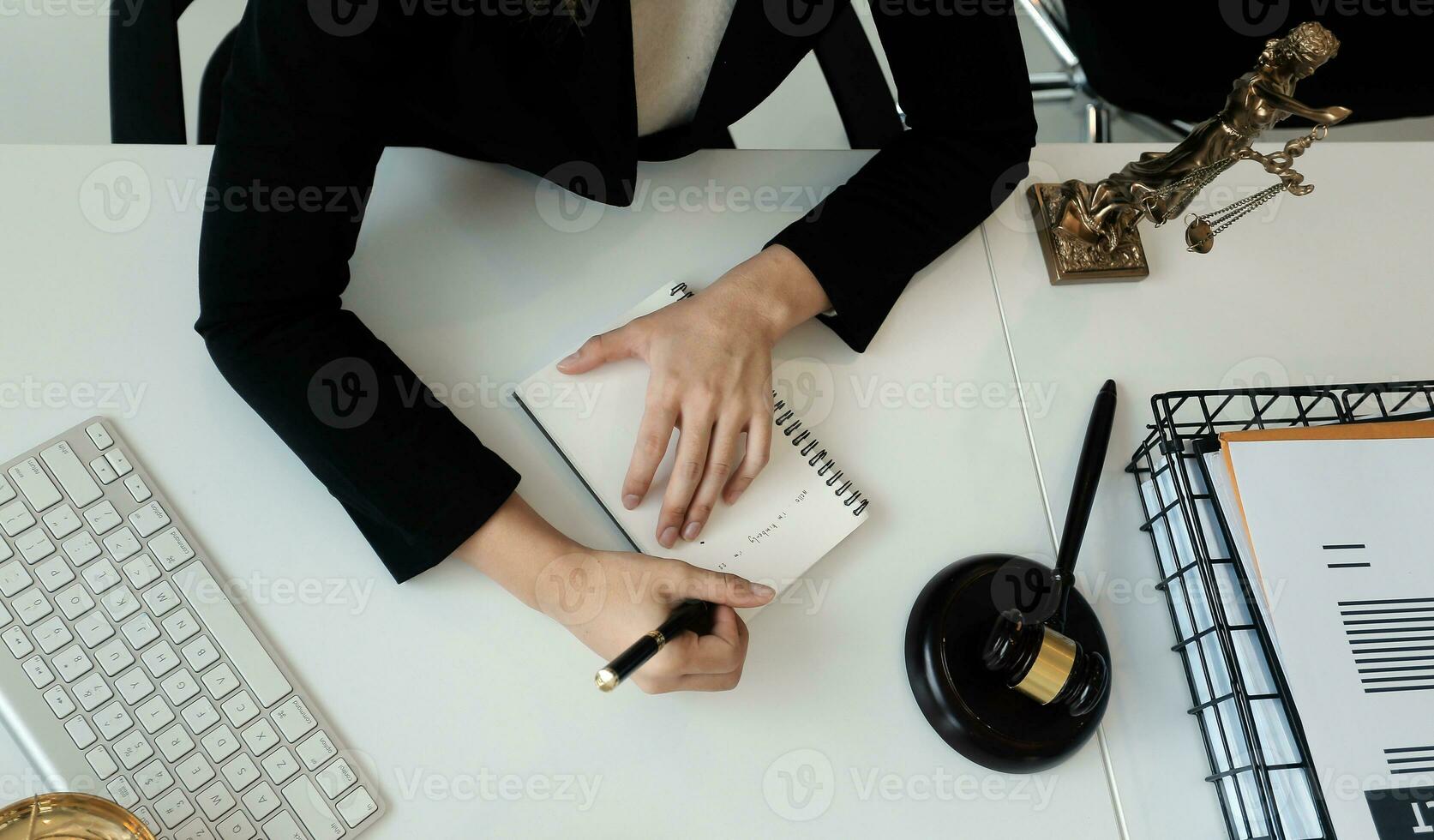 Male lawyer working with contract papers and wooden gavel on tabel in courtroom. justice and law ,attorney, court judge, concept. photo