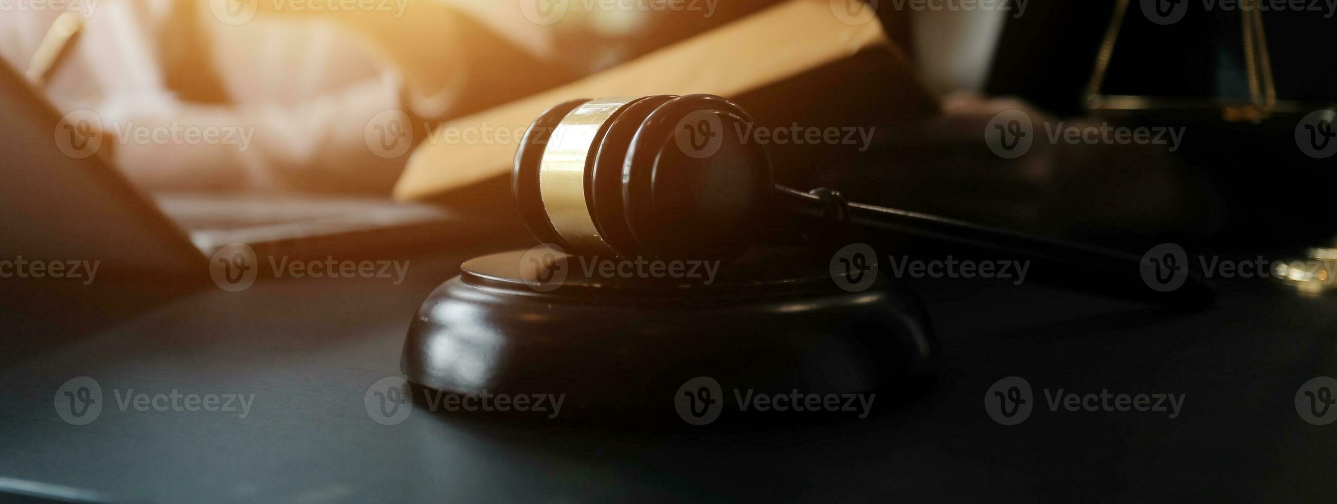 Male lawyer working with contract papers and wooden gavel on tabel in courtroom. justice and law ,attorney, court judge, concept. photo