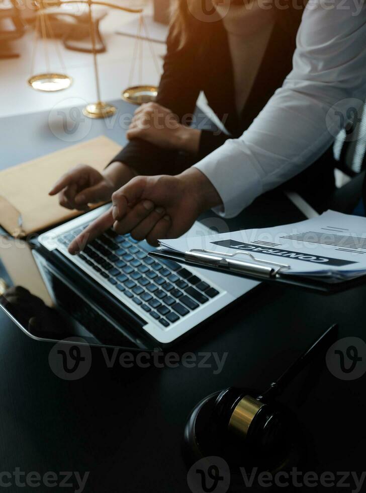 Male lawyer working with contract papers and wooden gavel on tabel in courtroom. justice and law ,attorney, court judge, concept. photo