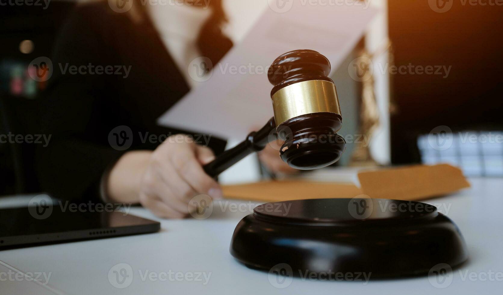 Male lawyer working with contract papers and wooden gavel on tabel in courtroom. justice and law ,attorney, court judge, concept. photo