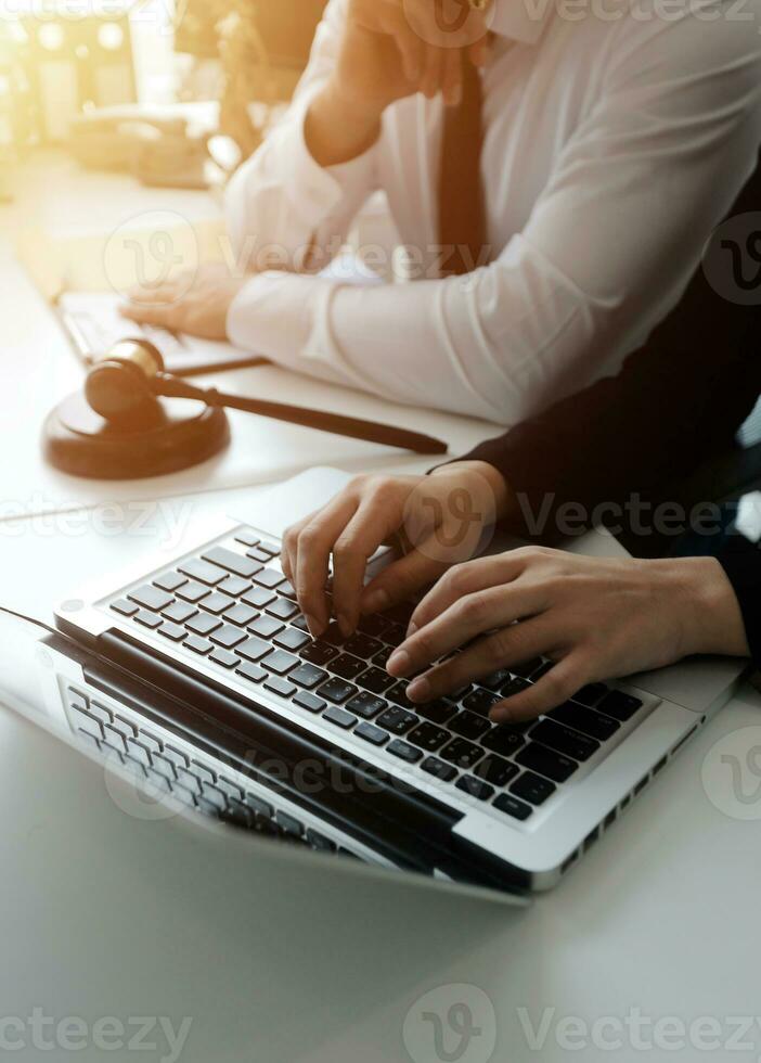 Male lawyer working with contract papers and wooden gavel on tabel in courtroom. justice and law ,attorney, court judge, concept. photo