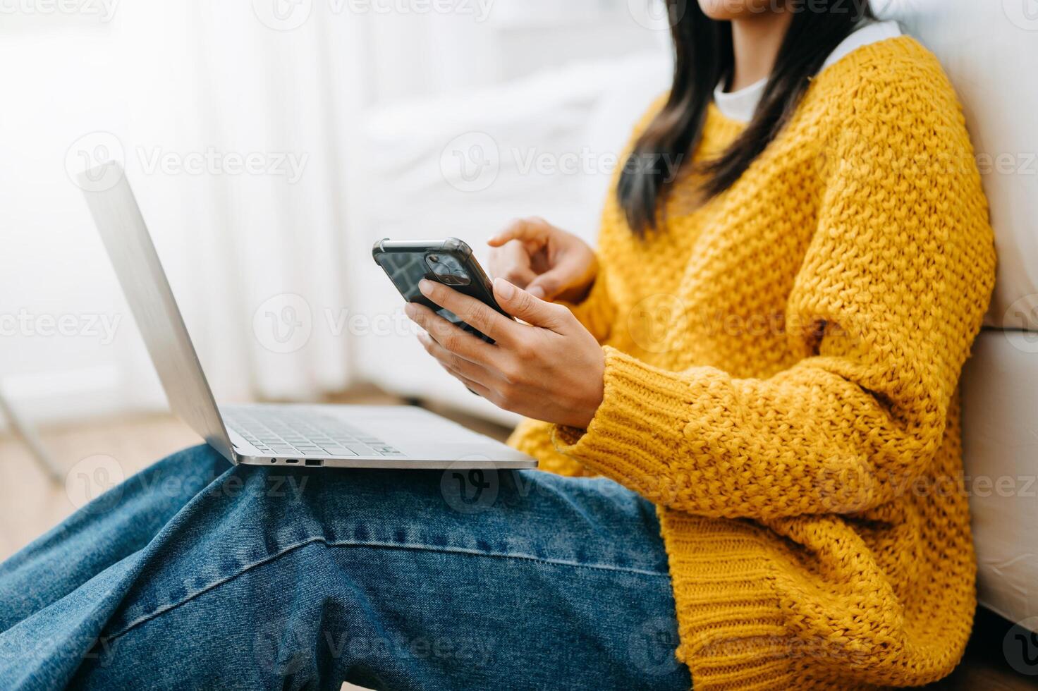 Woman using smart phone for mobile payments online shopping, omni channel, sitting on table, virtual icons photo