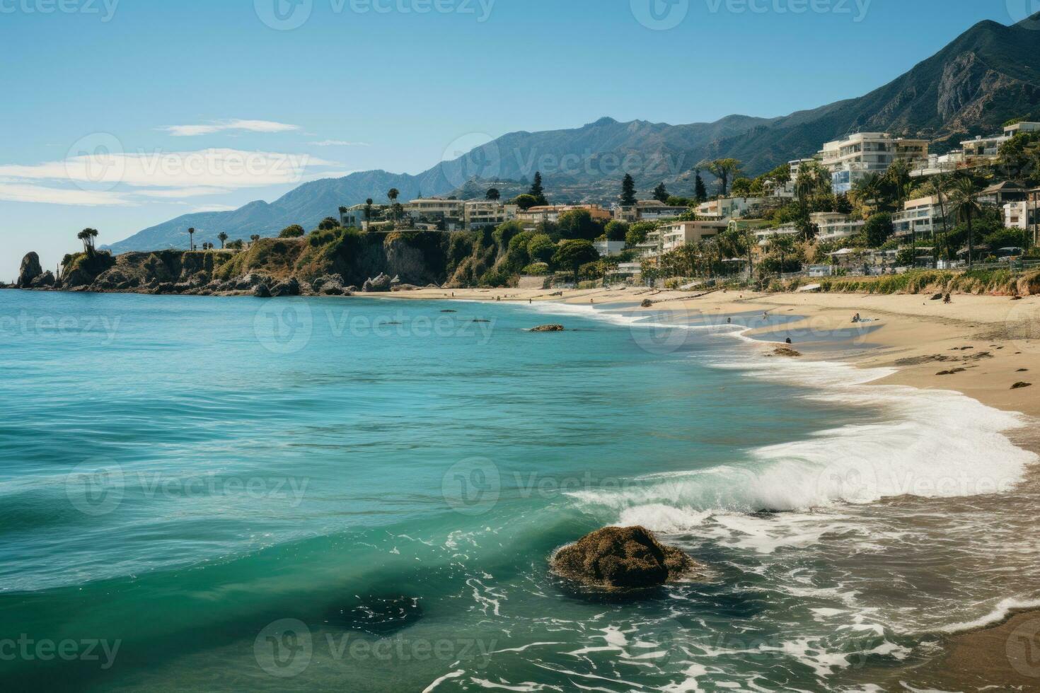 Beach view showing calm waves crashing on golden sand on a perfect summer day. View of the coastline in the town of Malibu, California. photo