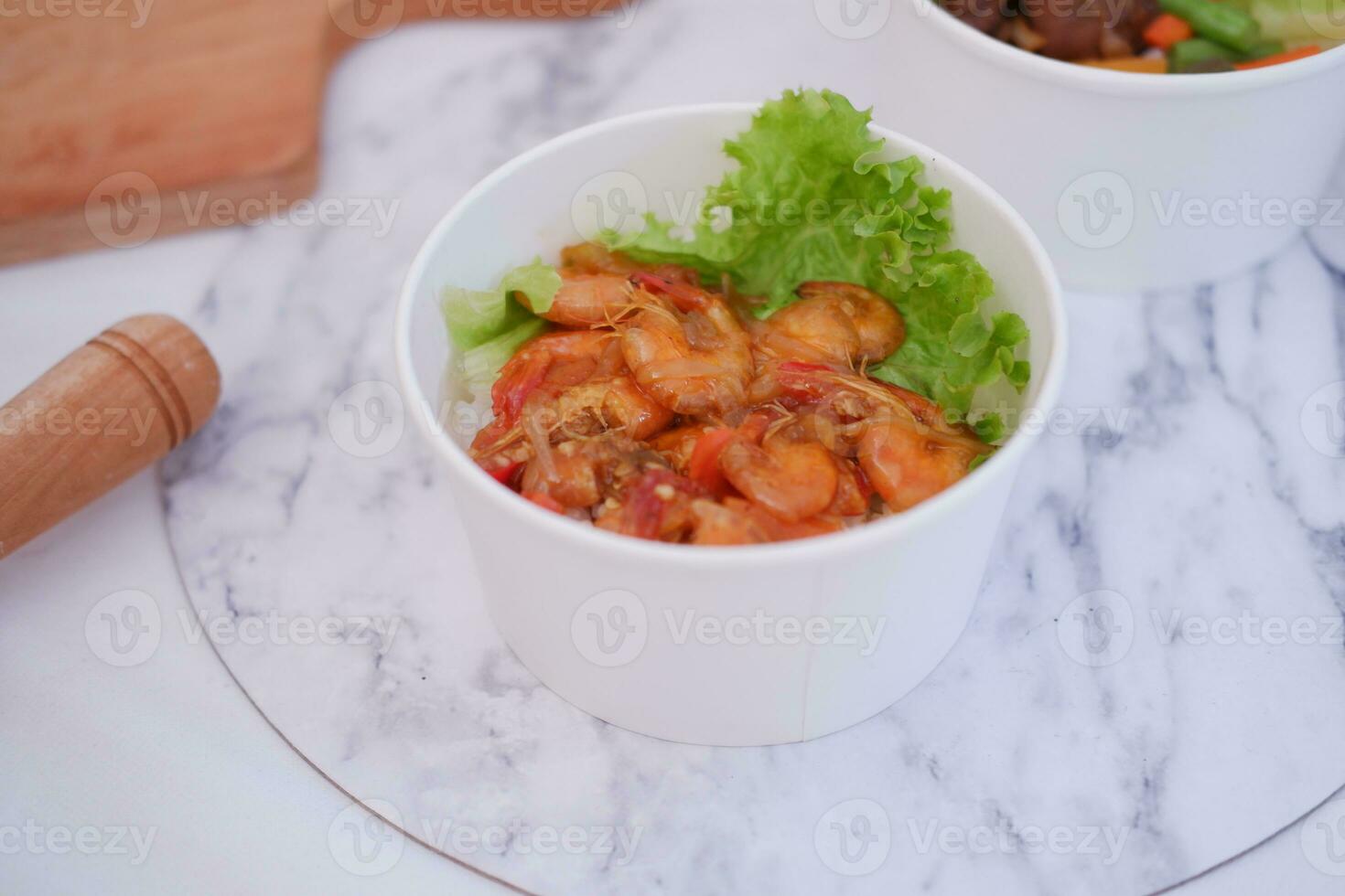 Shrimp salad in white bowl table background, top view photo