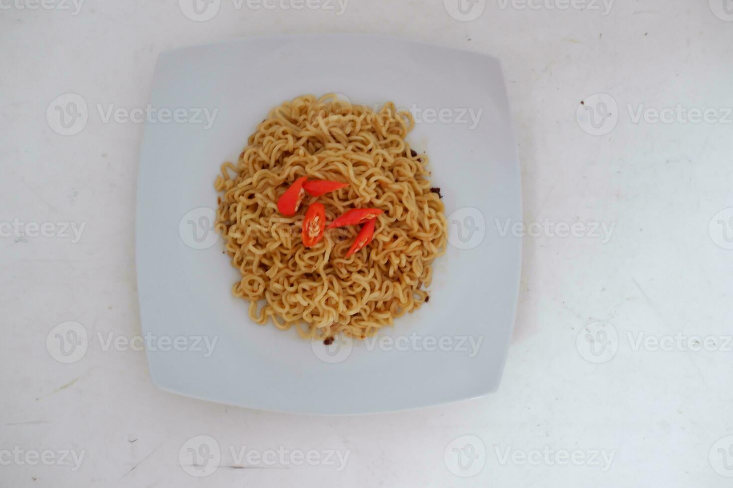 Instant noodle with fried chicken and rice on white plate photo