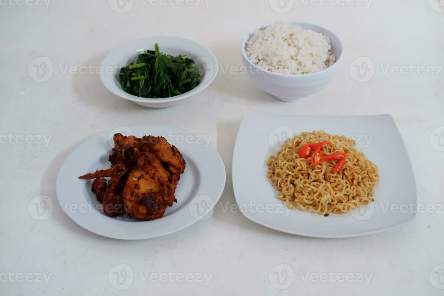 Instant noodle with fried chicken and rice on white plate photo