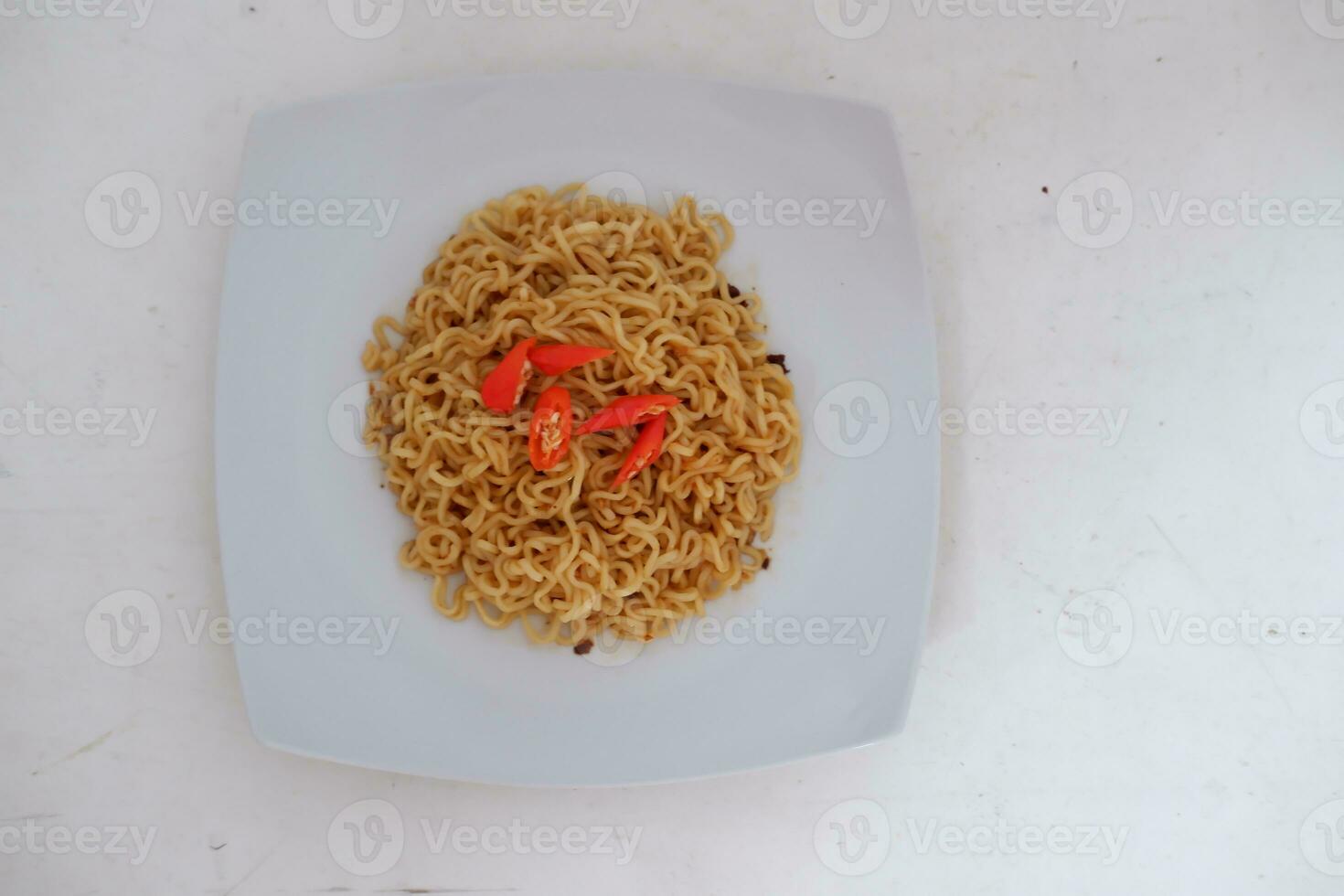 Instant noodle with fried chicken and rice on white plate photo