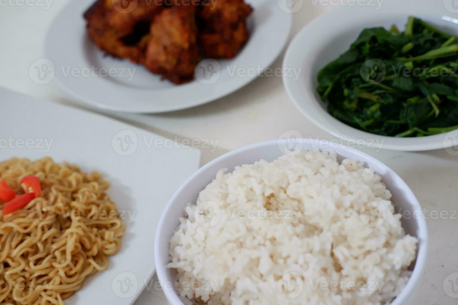 Instant noodle with fried chicken and rice on white plate photo