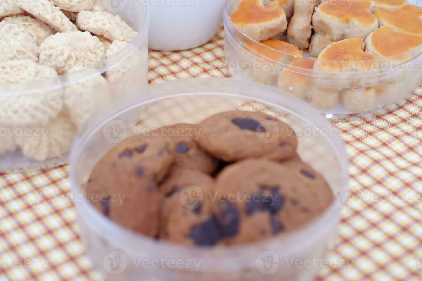 Homemade cookies in plastic box on tablecloth. Selective focus. photo