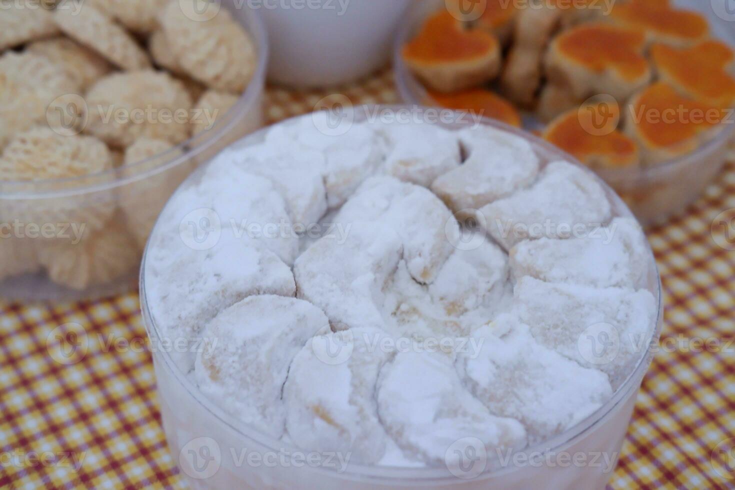 Coconut cookies in a glass bowl on checkered tablecloth photo