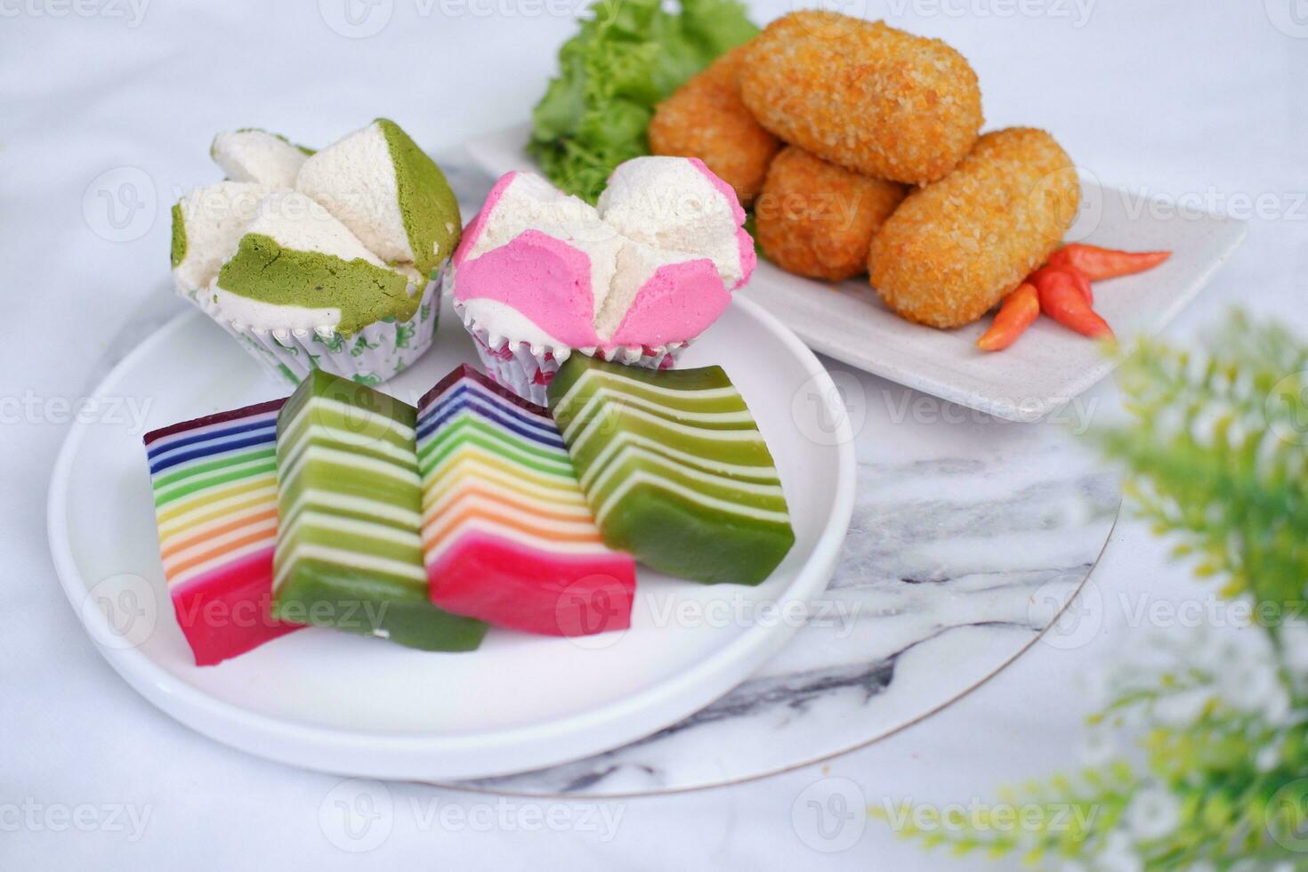 Fried croquettes, sponge cupcake and Rainbow sticky layer cake Indonesian traditional dessert photo