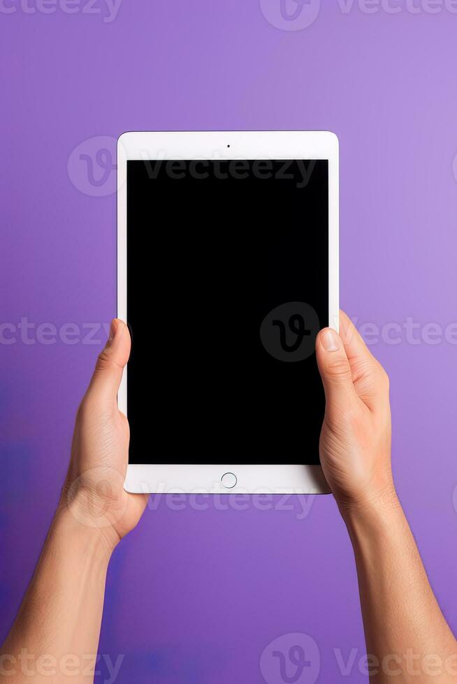 Hand holding tablet with mockup blank screen isolated on purple background. ai generated photo