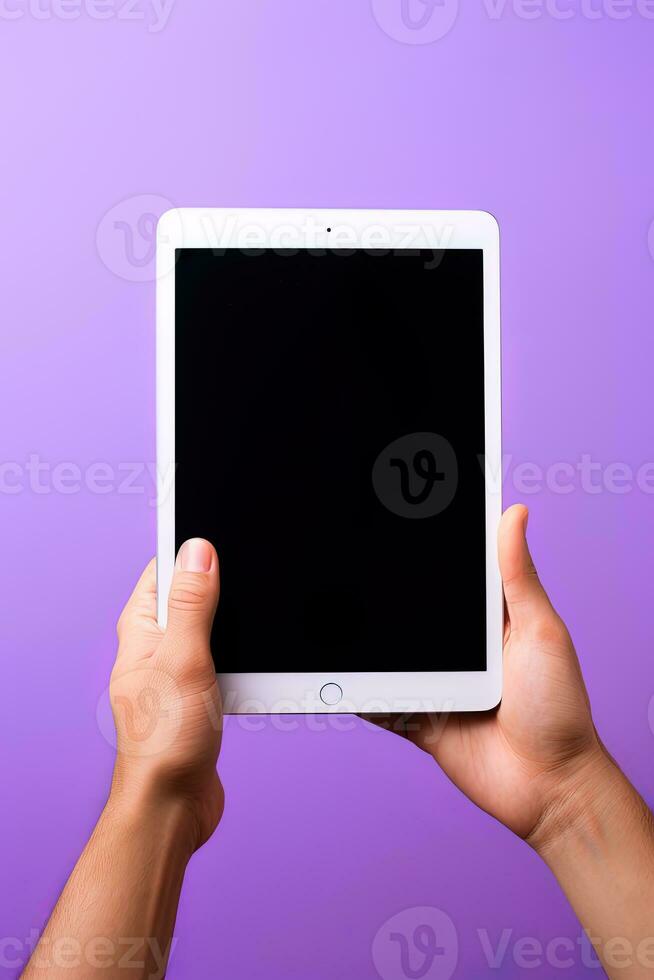 Hand holding tablet with mockup blank screen isolated on purple background. ai generated photo