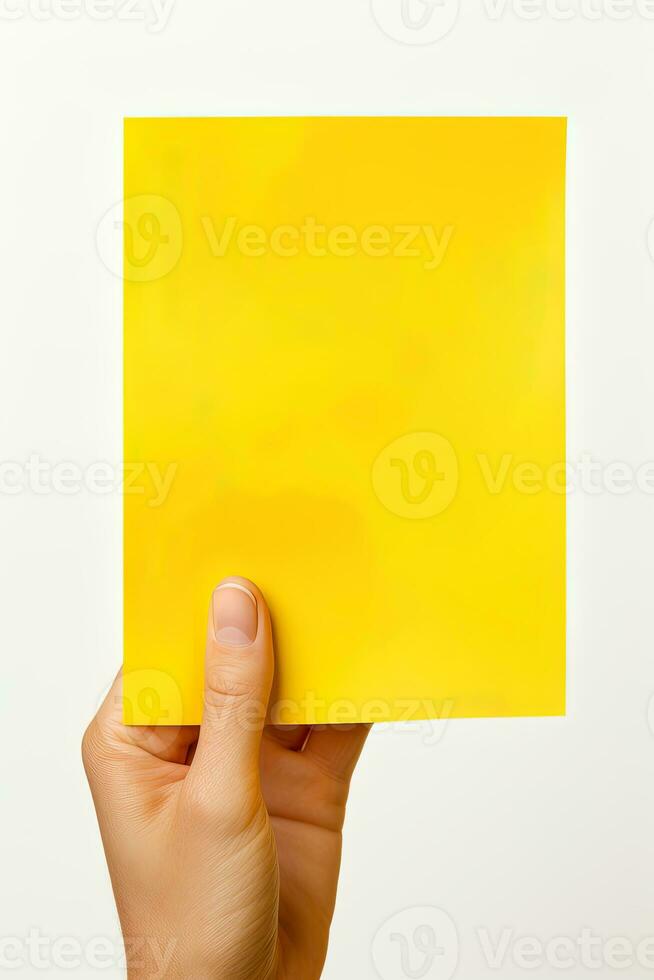 A human hand holding a blank sheet of yellow paper or card isolated on white background. ai generated photo