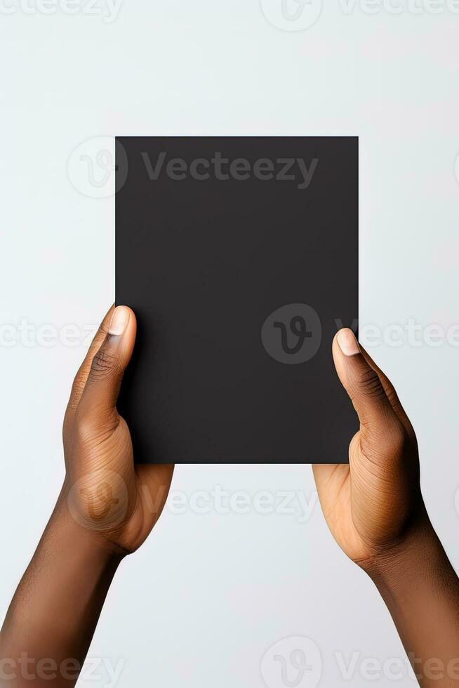A human hand holding a blank sheet of black paper or card isolated on white background. ai generated photo