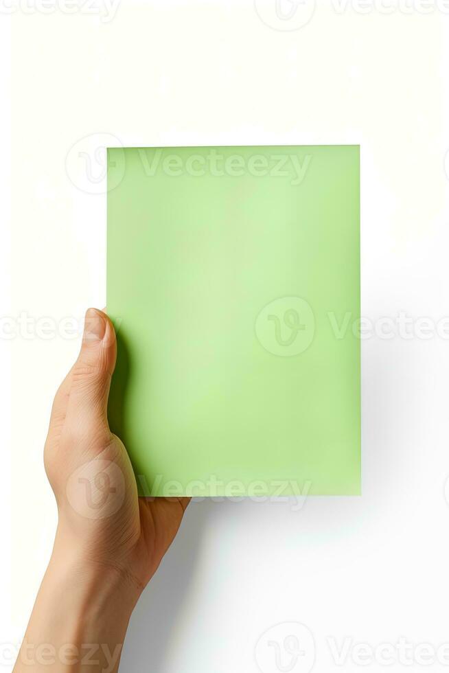 A human hand holding a blank sheet of green paper or card isolated on a white background. ai generated photo