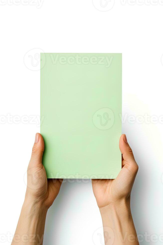 A human hand holding a blank sheet of green paper or card isolated on a white background. ai generated photo