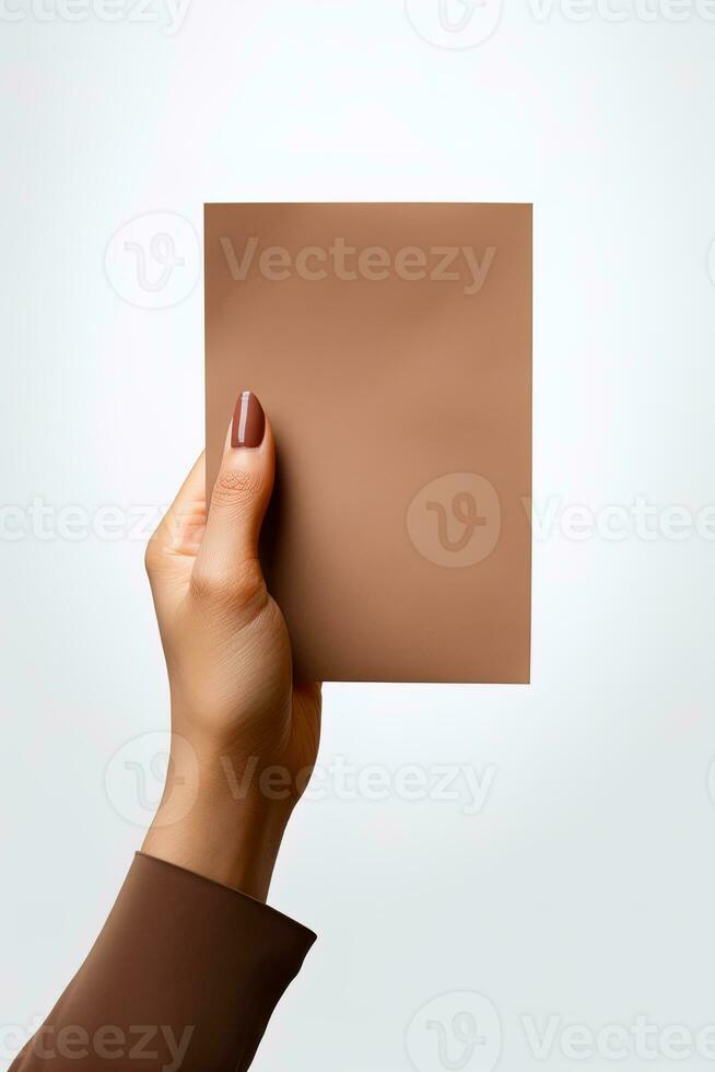 A human hand holding a blank sheet of brown paper or card isolated on a white background. ai generated photo