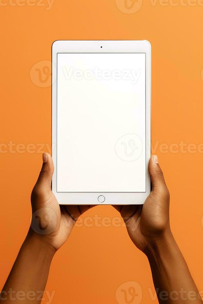 Hand holding tablet with mockup blank screen isolated on orange background. ai generated photo