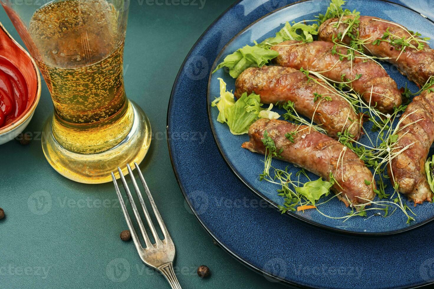 Fried sausages with glass of beer photo