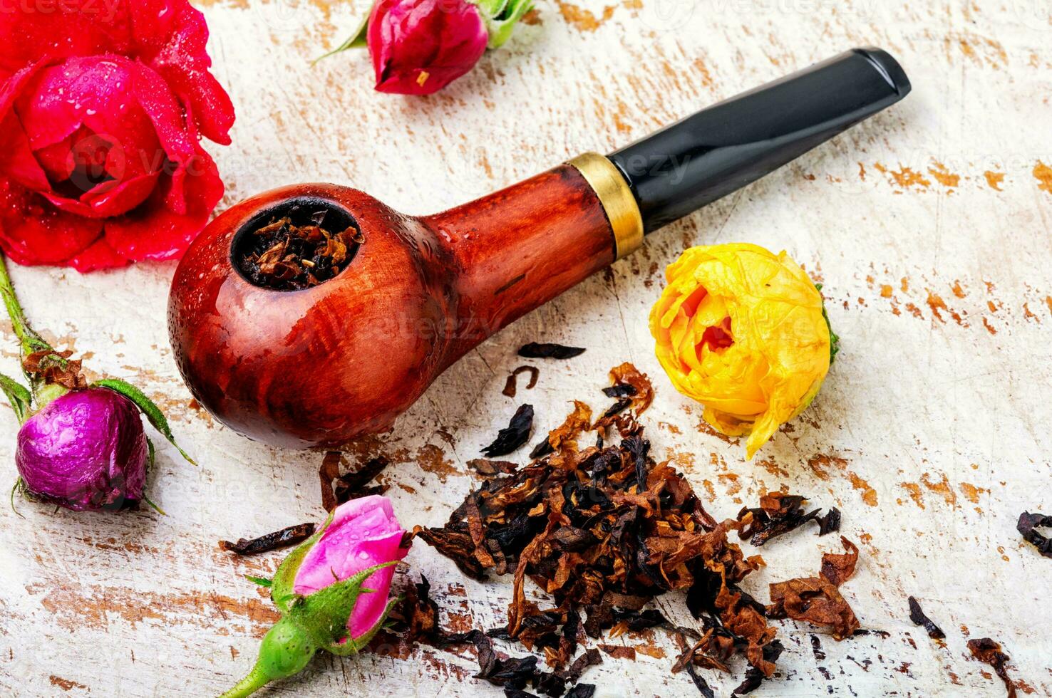 Smoking pipe and floral tobacco photo