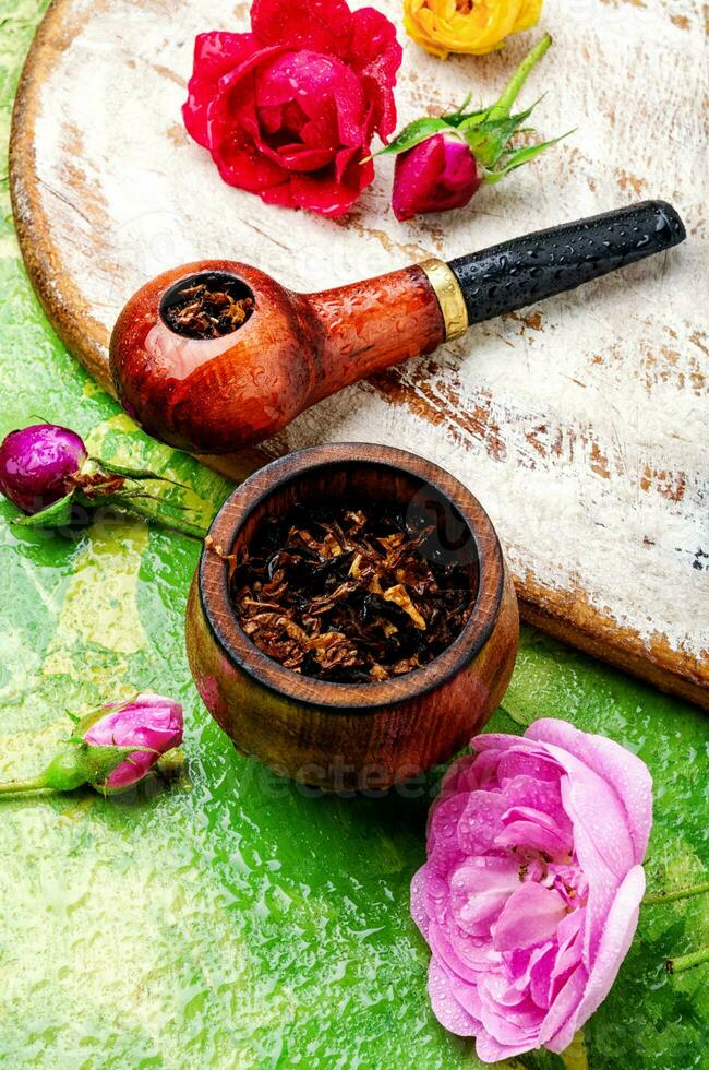Smoking pipe and floral tobacco photo