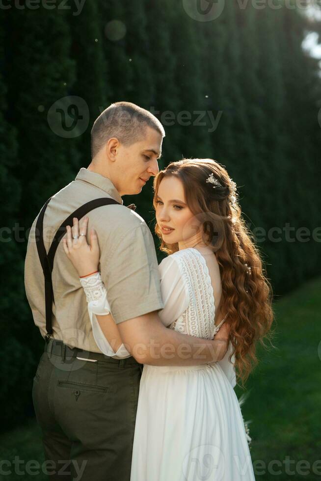 wedding walk of the bride and groom in a coniferous photo