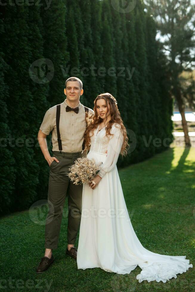 wedding walk of the bride and groom in a coniferous photo