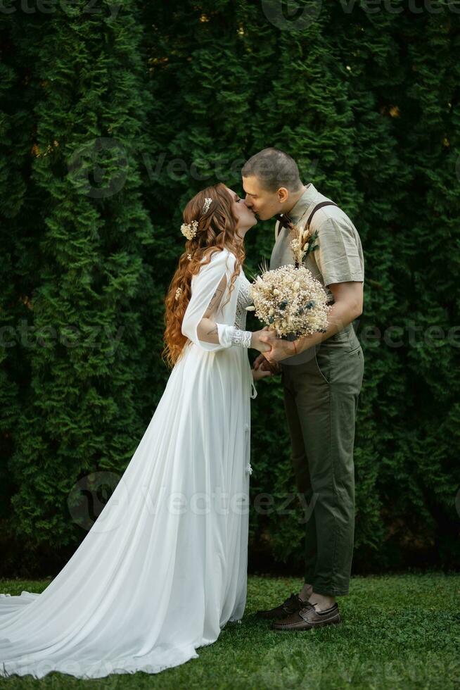 wedding walk of the bride and groom in a coniferous photo