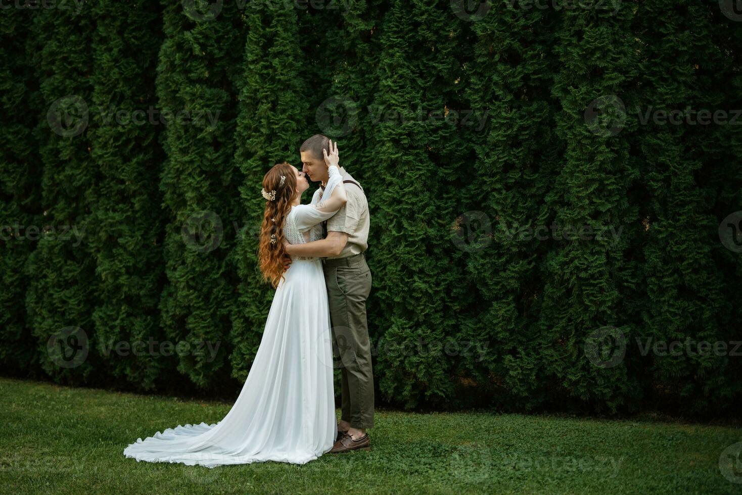 wedding walk of the bride and groom in a coniferous photo