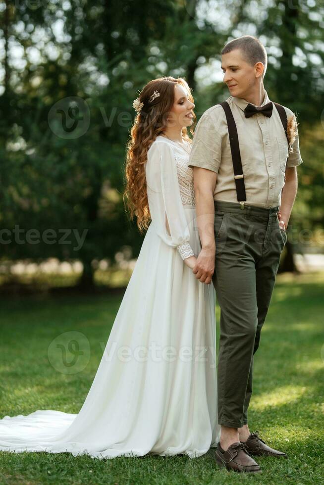 wedding walk of the bride and groom in a coniferous photo