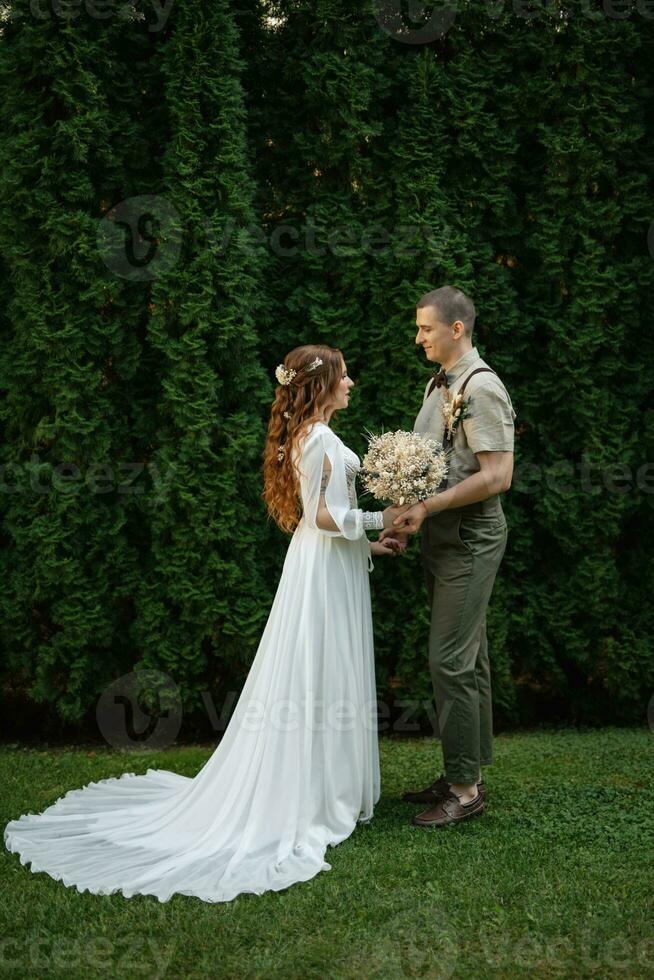 wedding walk of the bride and groom in a coniferous photo