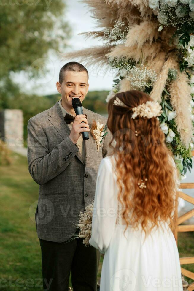 wedding ceremony of the newlyweds in a country cottage photo