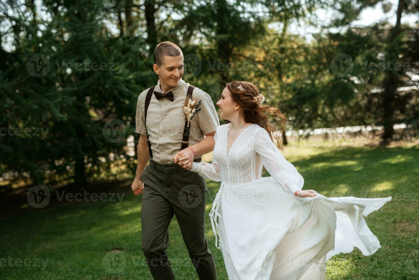 wedding walk of the bride and groom in a coniferous photo