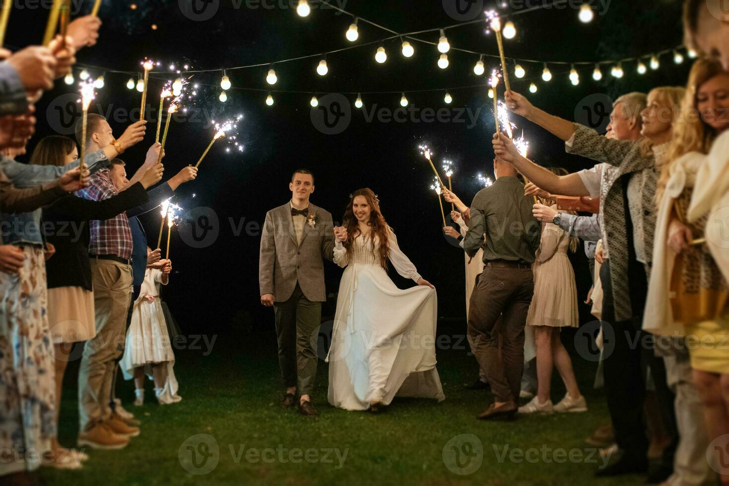 newlyweds at a wedding of sparklers photo
