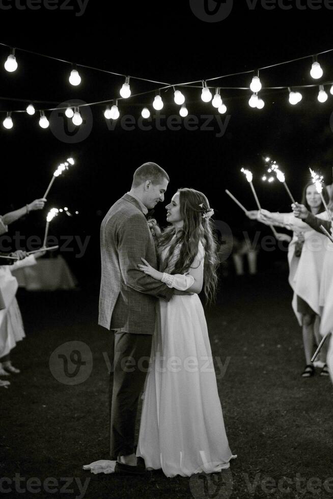 newlyweds at a wedding of sparklers photo