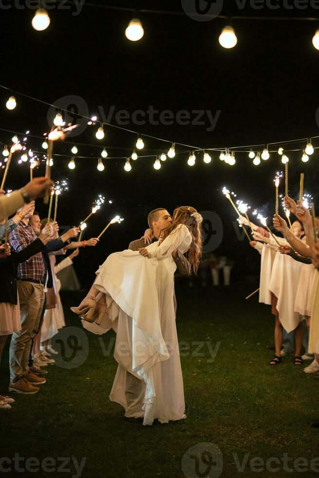 newlyweds at a wedding of sparklers photo