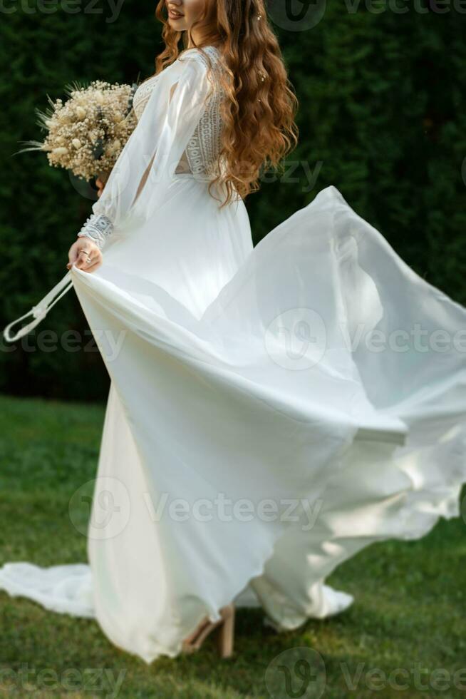 red-haired girl bride with a wedding bouquet photo