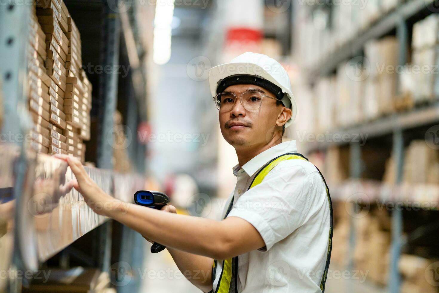 Male warehouse worker working with barcode scanner Work in a warehouse. Logistics and export industry concept. photo
