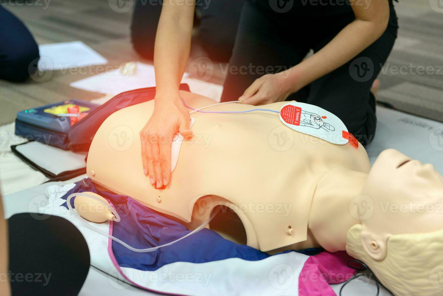 First aid cardiopulmonary resuscitation course using AED training. selective focus placing electrode photo