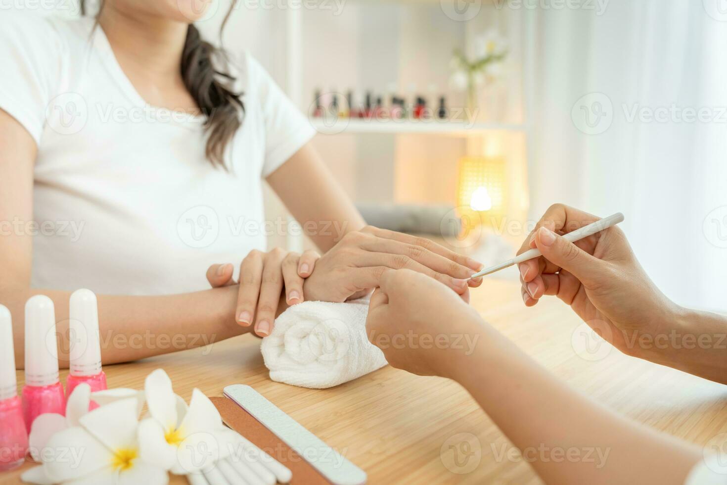 Woman receive care service by professional Beautician Manicure at spa centre. Nail beauty salon use nail file for Glazing treatment. manicurist make nail customer to beautiful. body care spa treatment photo