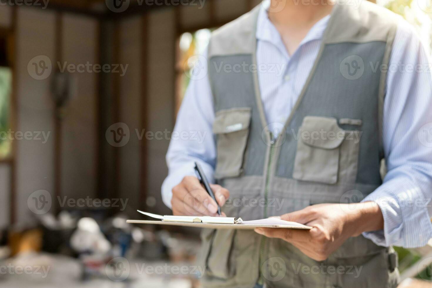 inspector or engineer is inspecting construction and quality assurance new house using a checklist. Engineers or architects or contactor work to build the house before handing it over to the homeowner photo