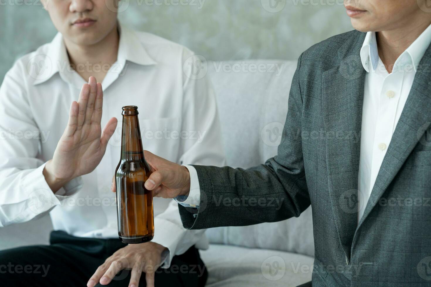 man refuses say no and avoid to drink alcohol at work, stopping hand sign male, alcoholism treatment, alcohol addiction, quit booze, Stop Drinking Alcohol. Refuse Glass liquor, unhealthy, reject photo
