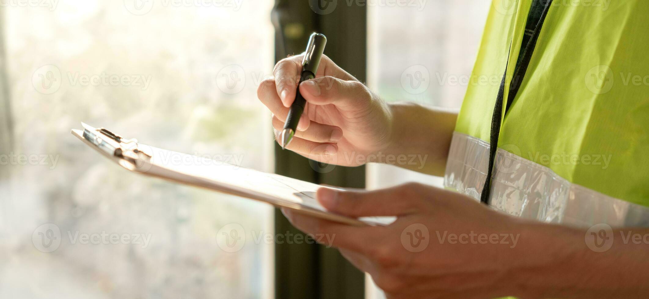 inspector or engineer is inspecting construction and quality assurance new house using a checklist. Engineers or architects or contactor work to build the house before handing it over to the homeowner photo