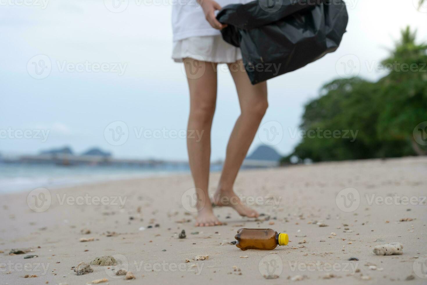 Save ocean. Volunteer pick up trash garbage at the beach and plastic bottles are difficult decompose prevent harm aquatic life. Earth, Environment, Greening planet, reduce global warming, Save world photo