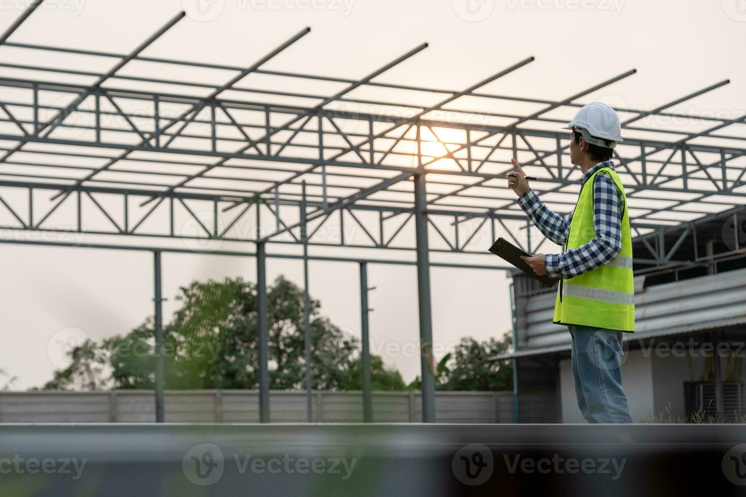 inspector or engineer is inspecting construction and quality assurance new house using a checklist. Engineers or architects or contactor work to build the house before handing it over to the homeowner photo