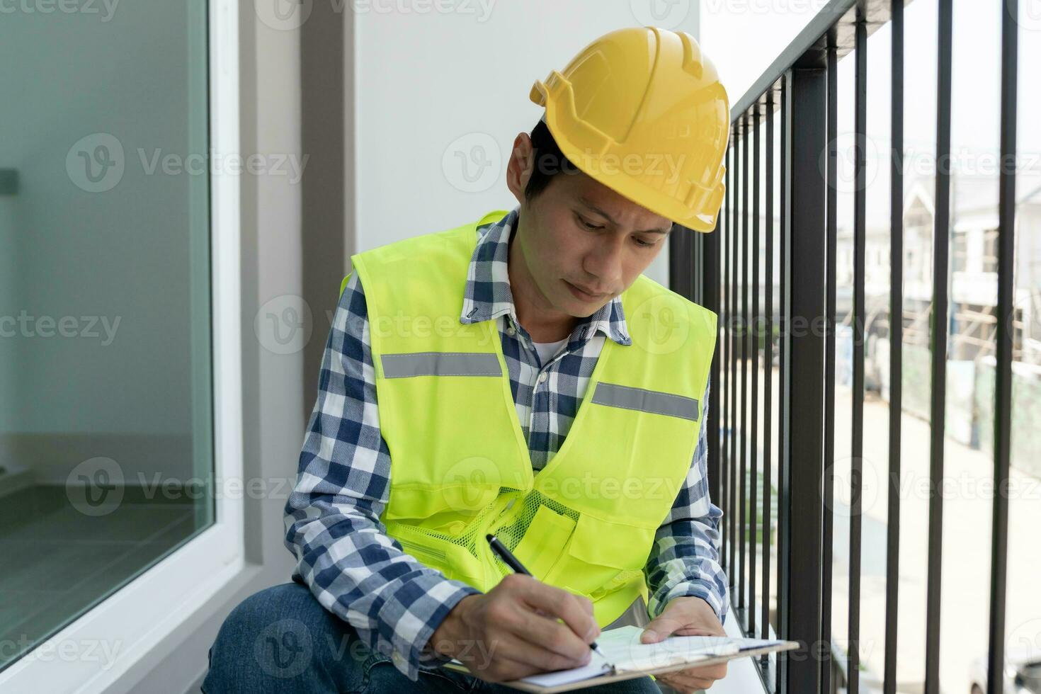 inspector or engineer is inspecting construction and quality assurance new house using a checklist. Engineers or architects or contactor work to build the house before handing it over to the homeowner photo