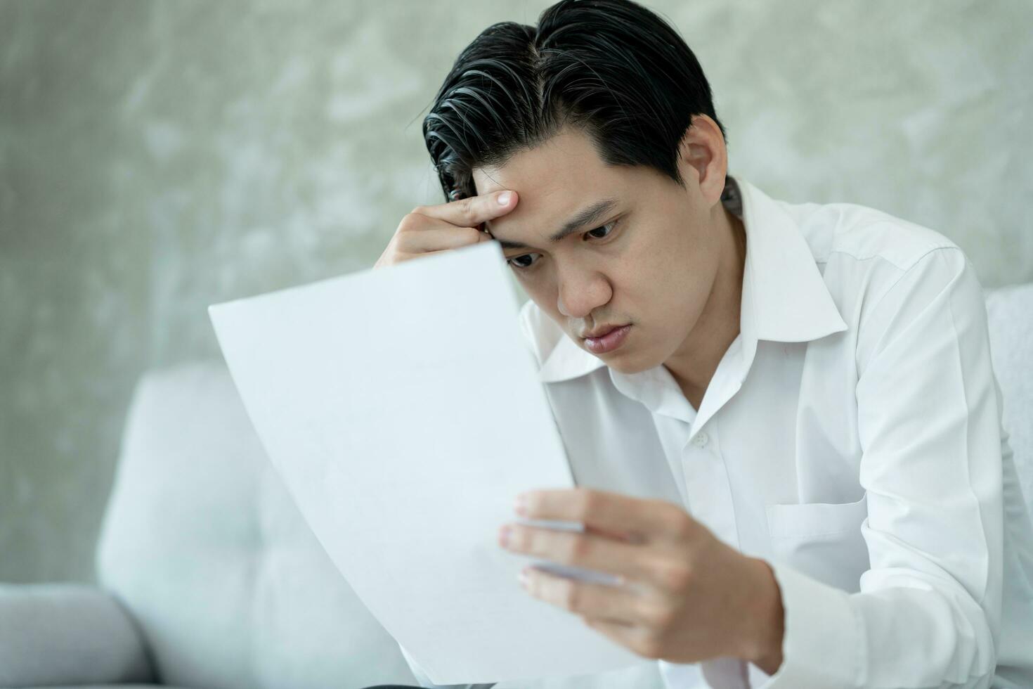 Stressed and headache asian man with large bills or invoices no money to pay to expenses and credit card debt. shortage, Financial problems, mortgage, loan, bankruptcy, bankrupt, poor, empty wallet photo