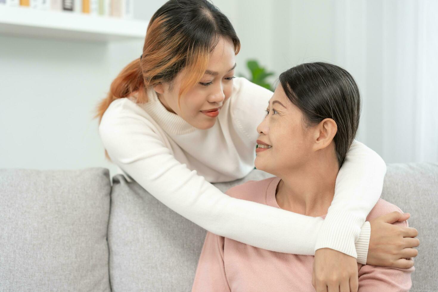 Mother day, cute asian teen girl hugging mature middle age mum. Love, kiss, care, happy smile enjoy family time. celebrate special occasion, happy birthday, merry Christmas. special day photo